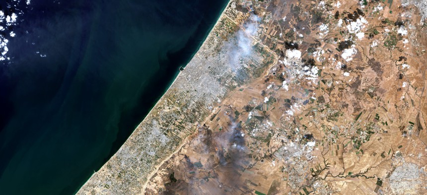 Satellite view of smoke plumes along the Gaza-Israel border, October 7, 2023. 