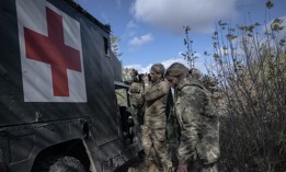 Health specialists return to their positions after transferring a wounded Ukrainian soldier to the hospital, in Avidiivka, Ukraine, on October 24, 2023. 