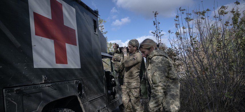 Health specialists return to their positions after transferring a wounded Ukrainian soldier to the hospital, in Avidiivka, Ukraine, on October 24, 2023. 
