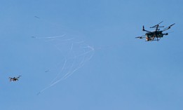 A DroneHunter F700 fires its net at a target drone in a demonstration.