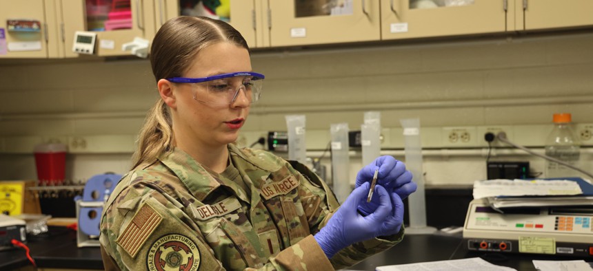 2nd Lt. Evon Delisle, a biomaterials research scientist, tests the strength of muskox hair at the Air Force Research Laboratory's Materials and Manufacturing Directorate, Wright-Patterson Air Force Base, Ohio.