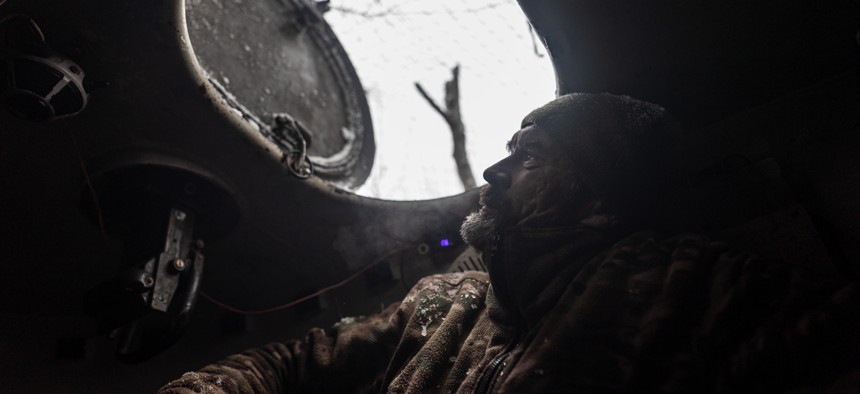 A Ukrainian soldier inside an artillery vehicle in his fighting position near Kharkiv, Ukraine on November 20, 2023. 