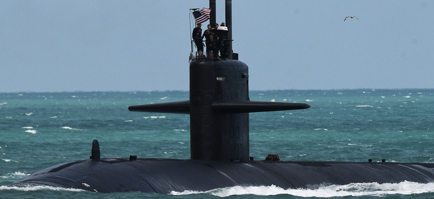 A nuclear-powered U.S. Navy submarine cruises into the Navy Port at Port Canaveral, Florida, in March 2023.