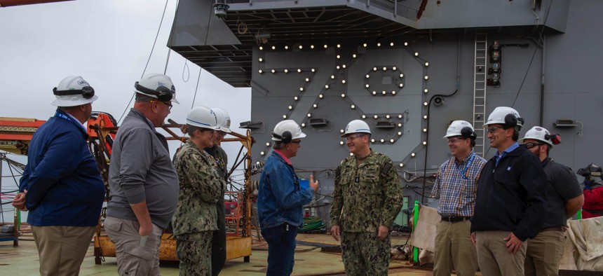 Naval Sea Systems Command's Rear Adm. Tom J. Anderson, discusses the construction of the aircraft carrier John F. Kennedy (CVN 79) with HII team leaders in Newport News, Virginia.