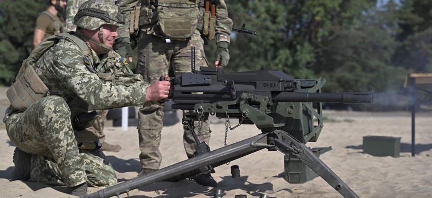 Commander of the Joint Forces the Armed Forces of Ukraine, lieutenant general Serhiy Nayev, fires a U.S.-made MK19 automatic grenade launcher during a military training exercise in Kyiv region on September 27, 2023.
