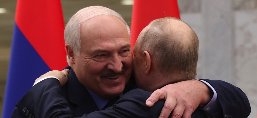 Belarussian President Alexander Lukashenko (L) embrasses Russian President Vladimir Putin (R) during the SCTO Summit on November 23, 2023,in Minsk, Belarus. 