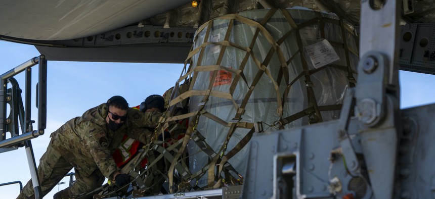 Airmen load cargo onto a C-17 Globemaster III at Joint Base Elmendorf-Richardson, Alaska, May 1, 2021, during an exercise.
