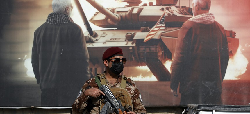 A paramilitary member of the Hashed al-shaabi forces stands guard during the funeral of a comrade who died in an American air strike, at the Hashed al-shaabi forces' headquarters in Baghdad on January 25, 2024. 