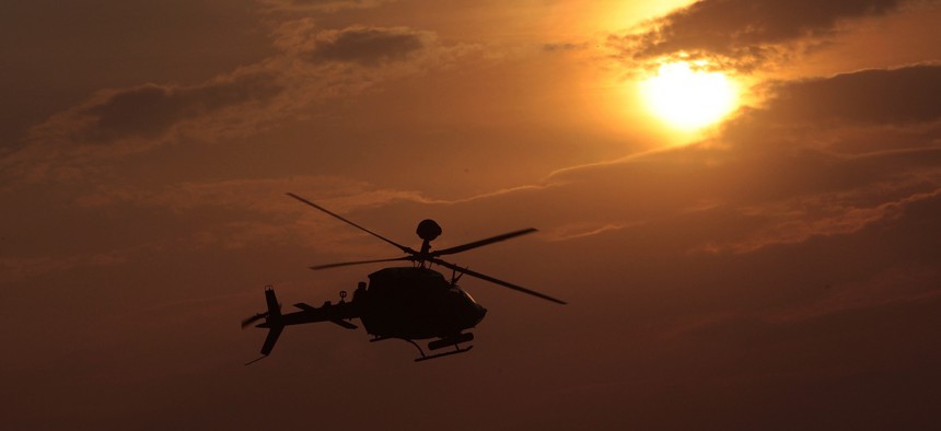 In this 2009 photo, an OH-58 Kiowa helicopter flies in Kandahar Province, Afghanistan.