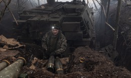 A Ukrainian soldier gets ready to pick up artillery shells at his fighting position near Bakhmut, Ukraine, on February 22, 2024. 