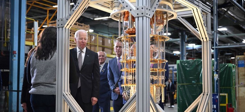 US President Joe Biden looks at a quantum computer as he tours the IBM facility in Poughkeepsie, New York, on October 6, 2022. - IBM hosted US President Joe Biden Thursday to celebrate the announcement of a $20-billion investment in semiconductors, quantum computing and other cutting-edge technology in New York state.