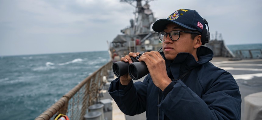 Seaman Xi Chan stands lookout on the flight deck of the Arleigh-Burke class guided missile destroyer USS Barry (DDG 52) underway in the Taiwan Strait.