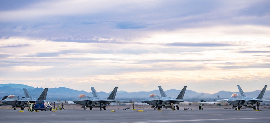 U.S. Air Force Airmen marshal F-22 Raptors assigned to Elmendorf Air Force Base to a stop and conduct post-flight checks at Nellis Air Force Base, Nevada, Jan. 31, 2024. 