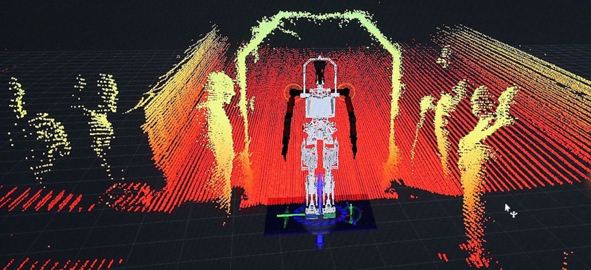 Virginia Tech's Team Valor semi-autonomous ESCHER (Electromechanical Series Compliant Humanoid for Emergency Response) robot uses LIDAR laser mapping to create a 3-D image of its surroundings during the second day of the Defense Advanced Research Projects Agency (DARPA) Robotics Challenge at the Fairplex June 6, 2015 in Pomona, California.
