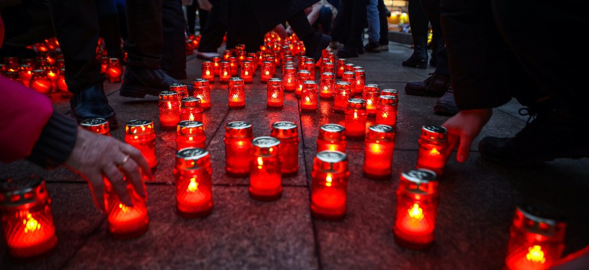 People lay carnations and light up candles near the chapel of St. Nicholas the Wonderworker to commemorate the people who were killed during the terrorist attack at Moscow concert hall, on March 25, 2024