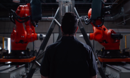 A still from the Machina Labs website depicting AI-assisted robotic parts forming