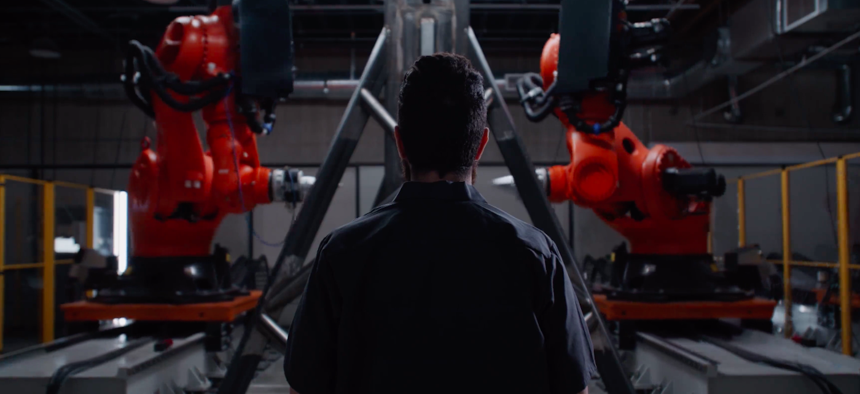 A still from the Machina Labs website depicting AI-assisted robotic parts forming
