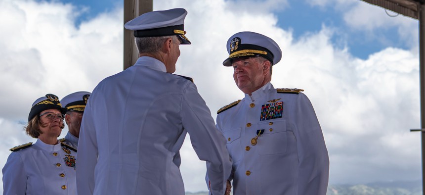 Adm. Samuel Paparo, right, turns over command of Commander, U.S. Pacific Fleet to Adm. Stephen Koehler during the COMPACFLT change of command ceremony onboard Joint Base Pearl Harbor-Hickam, April 4.