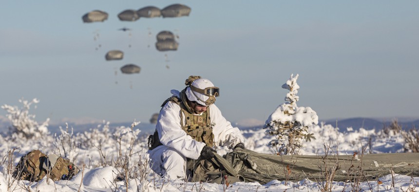 Army Pfc. David Hanson recovers a parachute after jumping onto Donnelly Drop Zone during Joint Pacific Multinational Readiness Center at Donnelly Training Area, Alaska, Feb. 8, 2024.