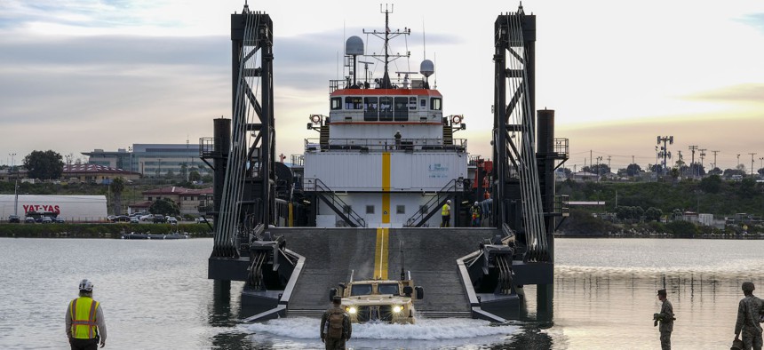  A Joint Light Tactical Vehicle drives off of the ramp of a Stern Landing Vessel, a modified oil-rig industry off-shore support vessel, in order to transport personnel off of the vessel as part of Project Convergence Capstone Four, Feb. 23, 2024 at the Del Mar Boat Basin, Camp Pendleton, CA.