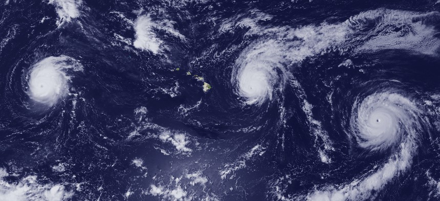 In this 2015 NOAA handout, three hurricanes churn in the Pacific Ocean in the vicinity of Hawaii.