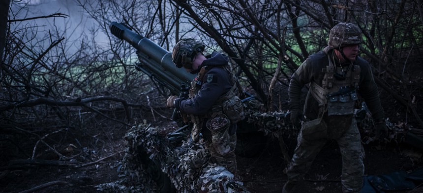 Ukrainian servicemen of Azov Brigade fire artillery near Lyman, Ukraine, on April 7, 2024.