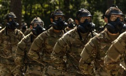 In this 2023 photo, Army recruits line up in gas masks during basic training at Fort Jackson, S.C. 