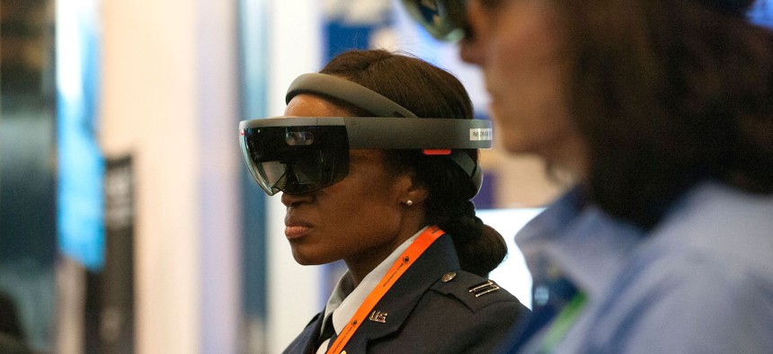 In this 2019 photo, attendees participate in an Augmented Reality demonstration hosted by Raytheon during the 35th Space Symposium in Colorado Springs, Colorado.