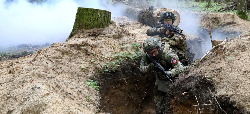 Soldiers practice clearing a trench during drills at a training area in Zhytomyr region, northern Ukraine, April 23, 2024.
