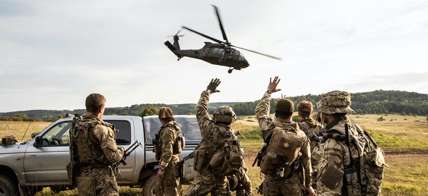 In this 2020 photo, Ukrainian special forces wave to their pilots from the 101st Combat Air Brigade after a flight mission during Exercise Combined Resolve 14 at Hohenfels, Germany.
