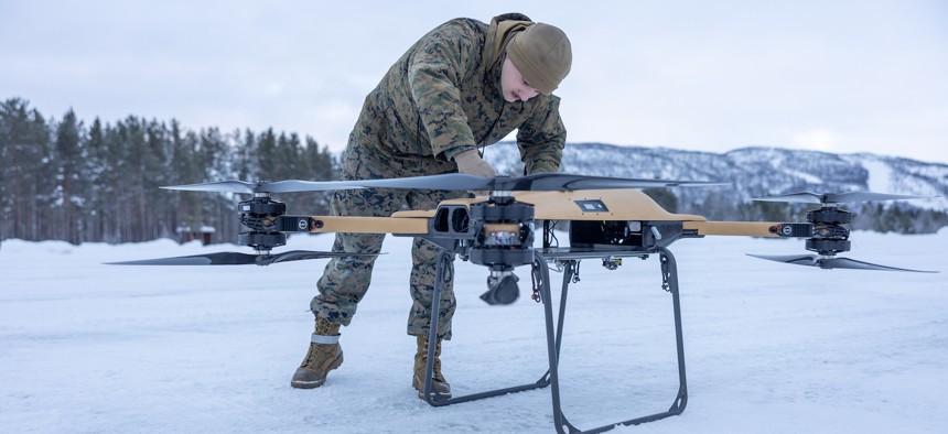 U.S. Marine Corps Lance Cpl. Andrew Hill, a motor transport operator assigned to Combat logistics Battalion 6, Combat Logistics Regiment 2, 2nd Marine Logistics Group, fastens the propeller arms on a Tactical Resupply Vehicle 150 (TRV) unmanned aircraft system during test flight operations in Setermoen, Norway, Feb. 6, 2024. 