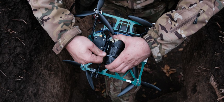A Ukrainian soldier attaches a shell to a FPV drone on October 26, 2023, in Zaporizhzhia Oblast, Ukraine. 