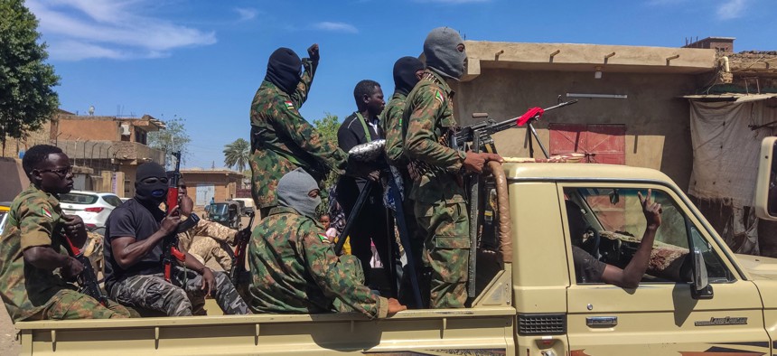 Supporters of the Sudanese armed popular resistance, which backs the army, ride on trucks in Gedaref in eastern Sudan on March 3, 2024, amid the conflict in Sudan between the army and paramilitaries. 