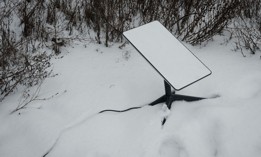 The antenna of the Starlink satellite-based broadband system is seen in the snow in Bakhmut, Ukraine, on February 16, 2023.