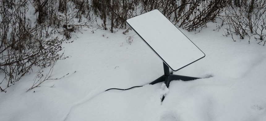 The antenna of the Starlink satellite-based broadband system is seen in the snow in Bakhmut, Ukraine, on February 16, 2023.