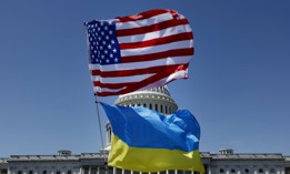 Flags for the United States and Ukraine billow in the wind off an activist's bicycle on the East Front Plaza of the U.S. Capitol Building on April 23, 2024, in Washington, DC. 