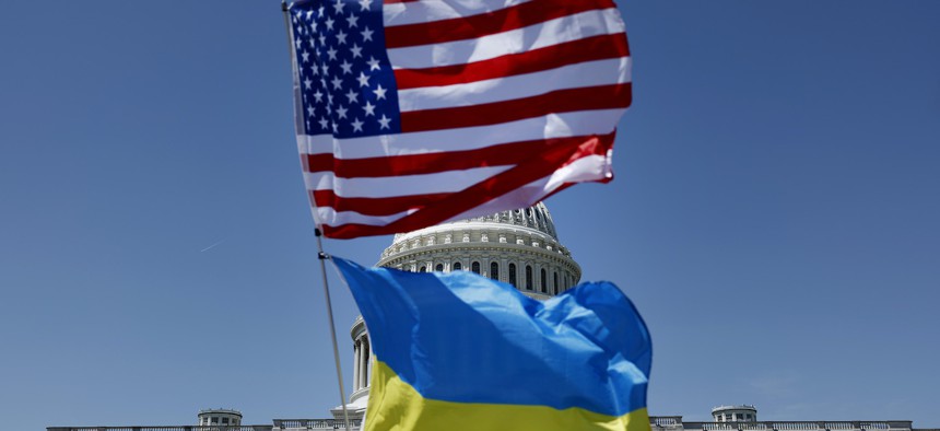 Flags for the United States and Ukraine billow in the wind off an activist's bicycle on the East Front Plaza of the U.S. Capitol Building on April 23, 2024, in Washington, DC. 