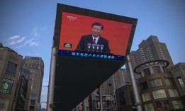 In this 2021 photo, Chinese President Xi Jinping is seen on a big screen showing the Chinese state television CCTV evening news .