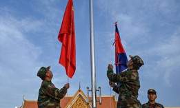 Cambodian soldiers raise flags of China and Cambodia at a military police base in Kampong Chhnang province. 