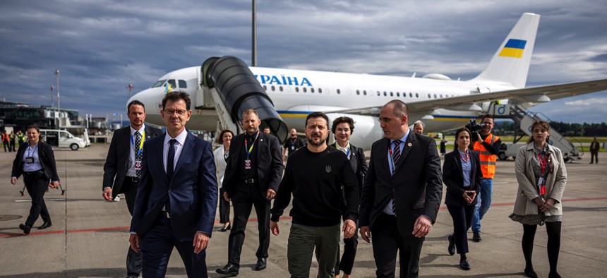 Ukraine's President Volodymyr Zelensky is welcomed by Switzerland's Ambassador to Ukraine Felix Baumann, left, and Deputy Head of Swiss Protocol Manuel Irman, right, at the Zurich airport on June 14, 2024, ahead of the Ukraine Peace Summit. 