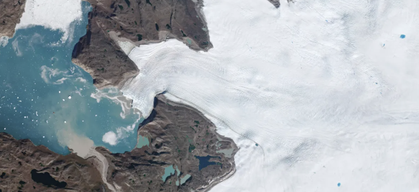 Newly calved icebergs, light-colored sediment carried by meltwater, and a handful of blue ponds on the ice are all signs of the heat wave visible in this September 4, 2022, PlanetScope image of a glacier on Greenland’s west coast.