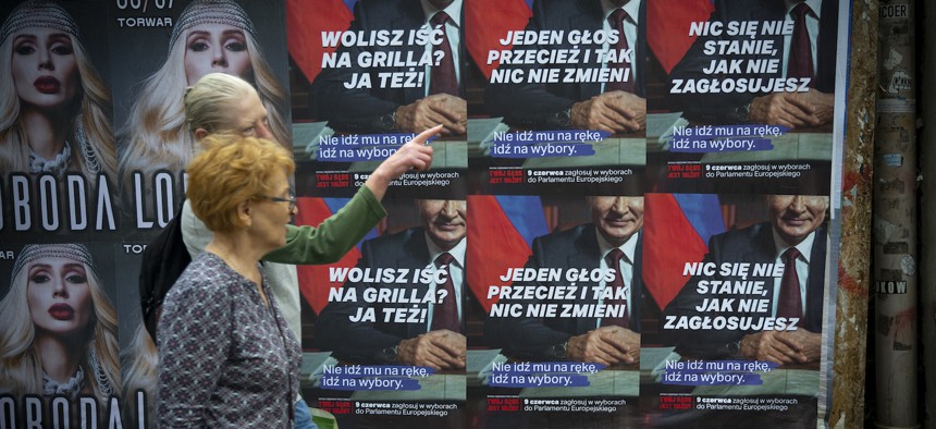 Posters urging people to vote in the European Parliament elections with a partial portrait of Russian President Vladimir Putin in Warsaw, Poland, June 4, 2024. 