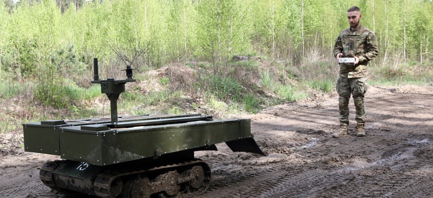 A serviceman with a ground robot during drills of the Liut (Fury) Brigade of the National Police of Ukraine at a training area in Zhytomyr region, Ukraine, on April 23, 2024. 