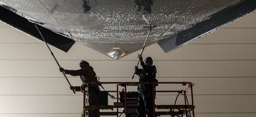 U.S. Air Force aircraft maintainers with the 167th Maintenance Group scrub the underside of a C-17 Globemaster III aircraft during a corrosion prevention wash at the 167th Airlift Wing, Martinsburg, West Virginia, on Mar. 5, 2023.