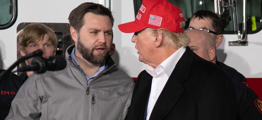 Sen. J.D. Vance, R-Ohio, talks with Donald Trump during an event in East Palestine, Ohio, on Feb. 22, 2023.