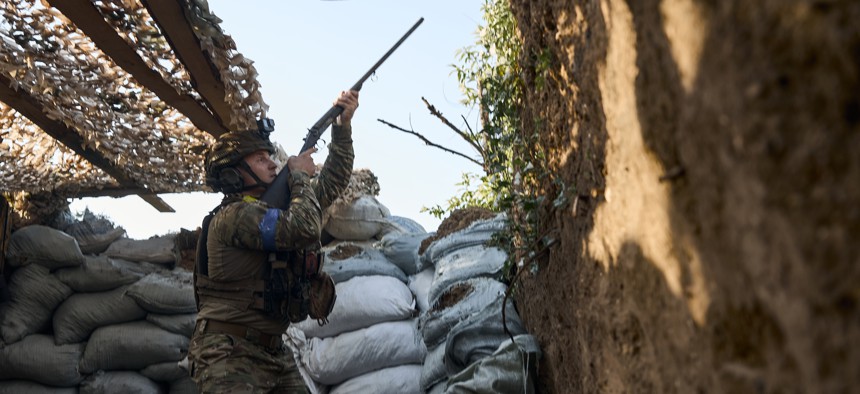 A Ukrainian soldier uses an old hunting rifle to take aim at an enemy drone just 100 meters from the Russian trenches in Ukraine's Toretsk region on July 5, 2024.