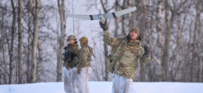 Soldiers with the Army's 11th Airborne Division launches a Raven drone April 2, 2023, during exercise Joint Pacific Multinational Readiness Center-Alaska 23-02 in the Yukon Training Area, Alaska.