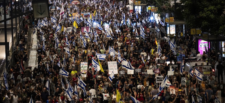  Thousands holding banners gather during a demonstration to demand a hostage swap deal with Palestinian factions in the Gaza Strip and the demanding early elections, in Tel Aviv, Israel on July 20, 2024