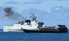 A Chinese warship sails next to a boat representing a hijacked vessel for the China-Cambodia Dragon Gold 2024 maritime exercises off the coast of Cambodia's Preah Sihanouk province on May 24, 2024.