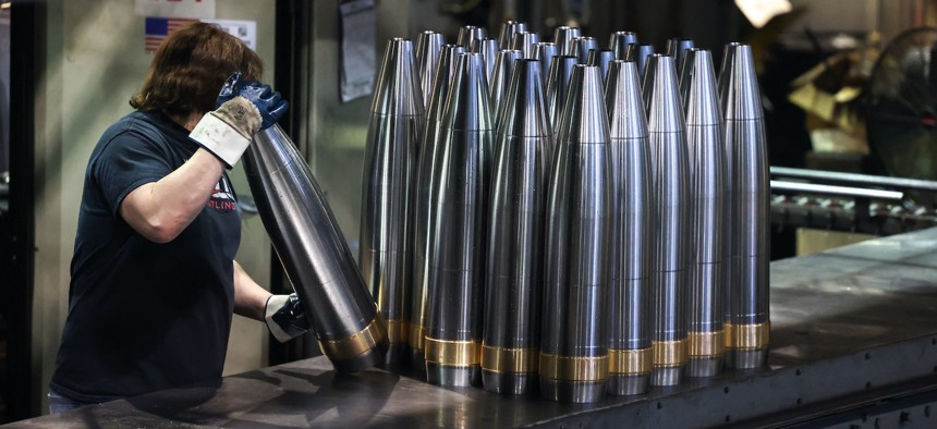 An employee handles 155 mm caliber shells destined for Ukraine, at the Scranton Army Ammunition Plant in Scranton, Pennsylvania on April 16, 2024. 